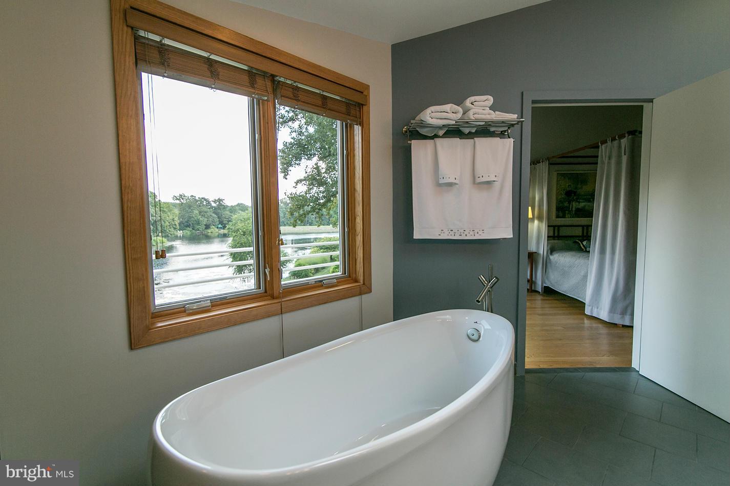 11580 Lake Newport Road Reston, VA 20194 - Photo 18 of 30 a white bath tub sitting in a bathroom next to a window