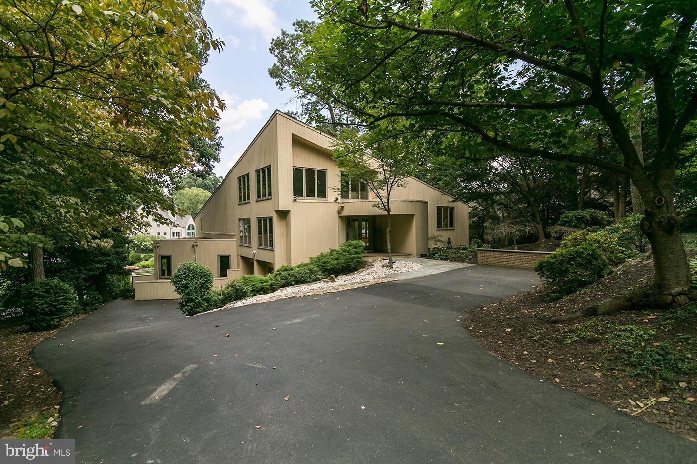 11580 Lake Newport Road Reston, VA 20194 - Photo 4 of 30 a front view of a house with a yard and garage