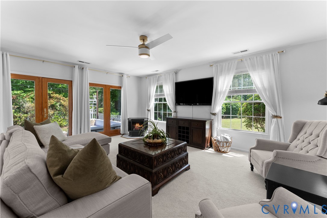 437 Plainview Road Kinsale, VA 22488 - Photo 13 of 63 a living room with furniture a large window and a fireplace
