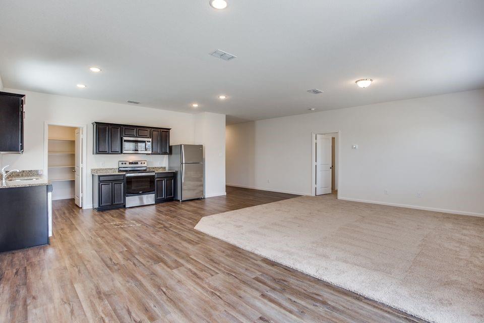 1815 Wolf Run Anna, TX 75409 - Photo 4 of 11 a kitchen with stainless steel appliances a refrigerator and a stove top oven