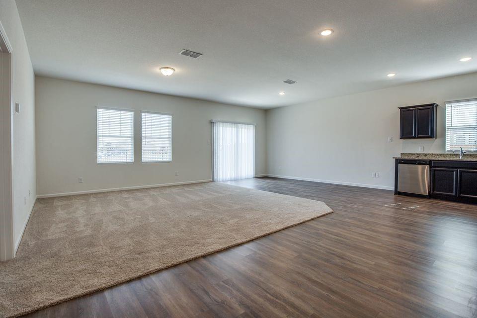 1815 Wolf Run Anna, TX 75409 - Photo 6 of 11 an empty room with wooden floor and windows