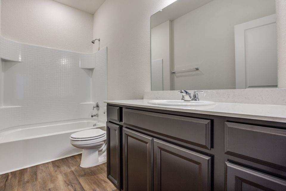 1815 Wolf Run Anna, TX 75409 - Photo 7 of 11 a bathroom with a sink toilet a mirror and bathtub