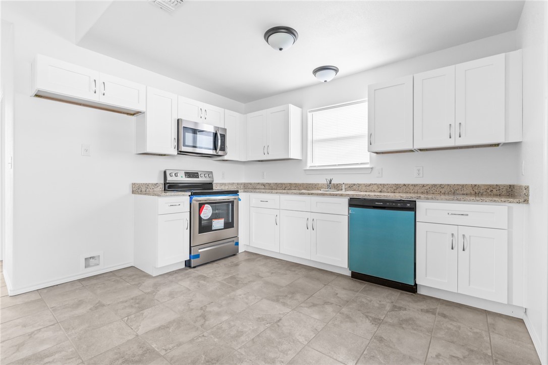 413 Whitney Court Rio Vista, TX 76093 - Photo 11 of 34 a kitchen with granite countertop cabinets stainless steel appliances and a sink