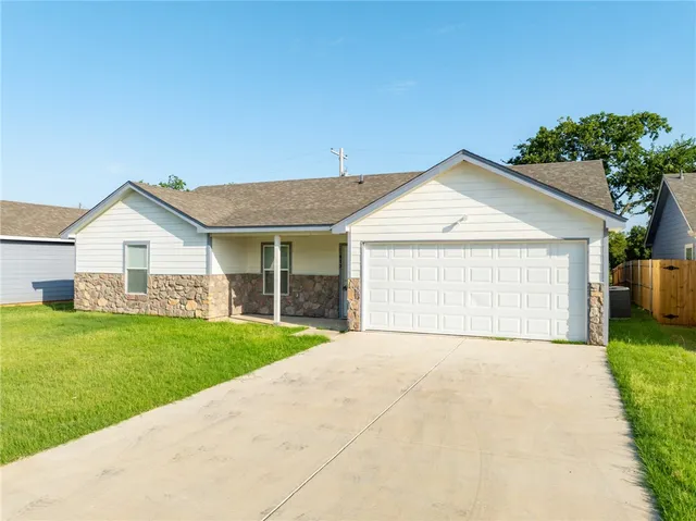 a view of a house with a yard and garage