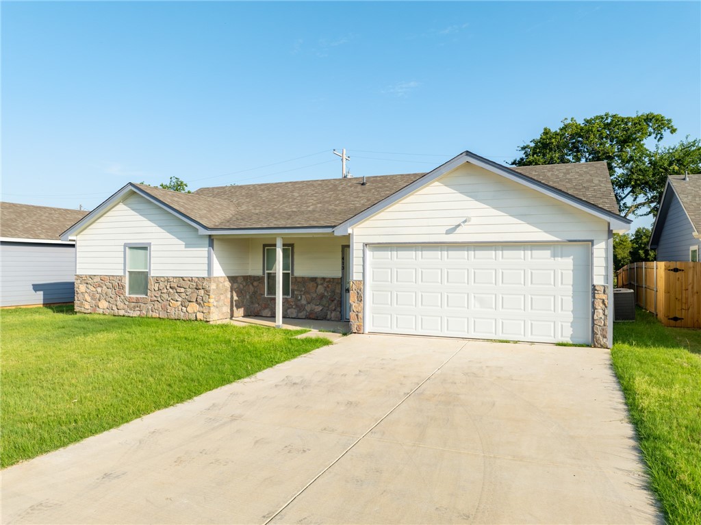 413 Whitney Court Rio Vista, TX 76093 - Photo 2 of 34 a view of a house with a yard and garage