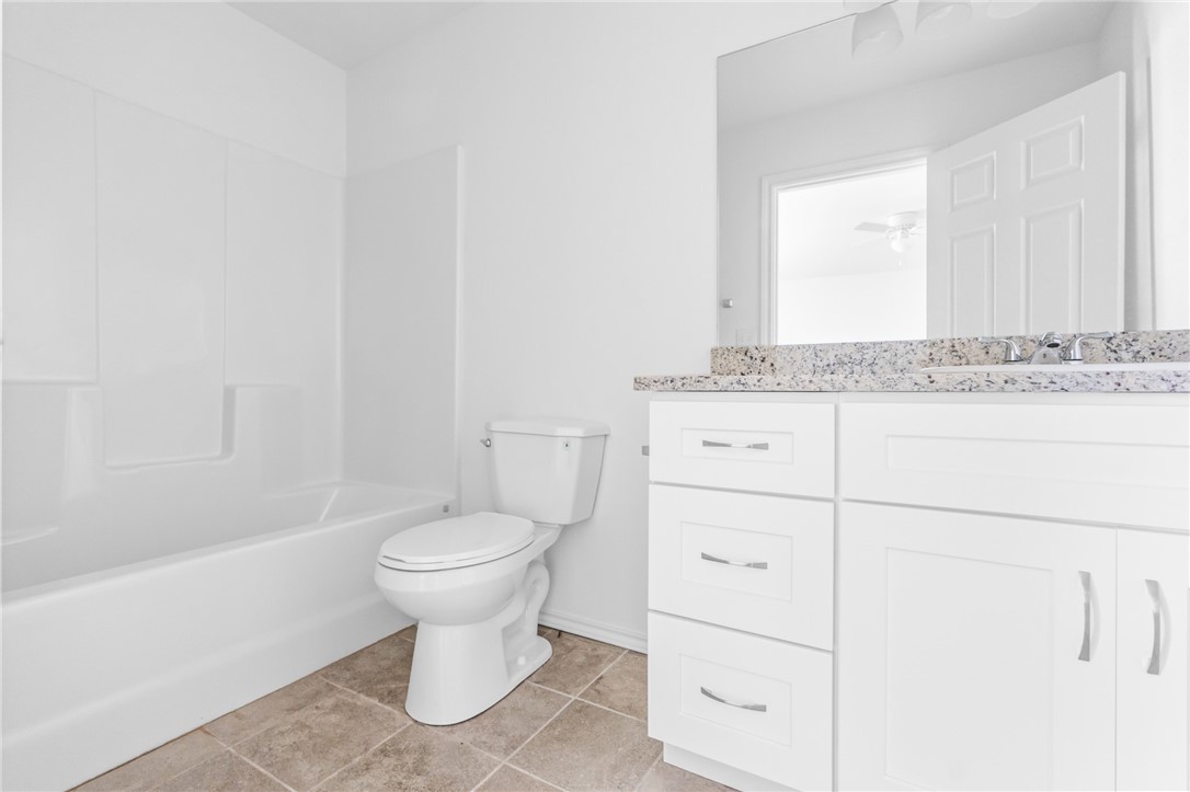 413 Whitney Court Rio Vista, TX 76093 - Photo 21 of 34 a bathroom with a sink a toilet and a mirror