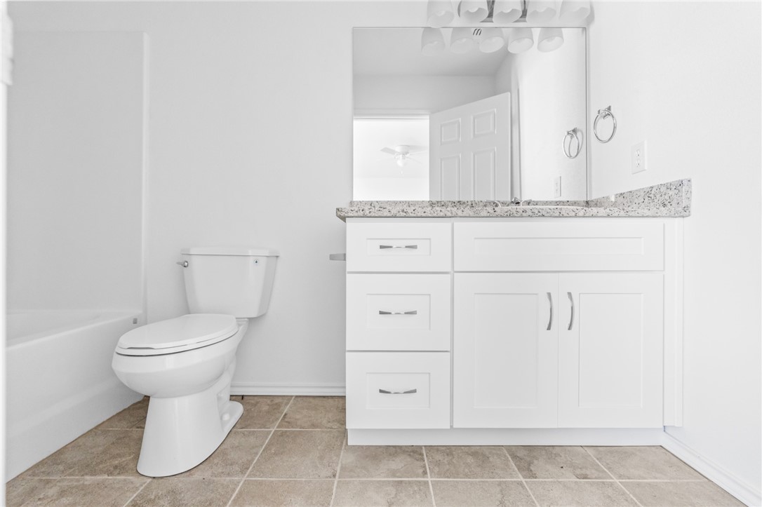413 Whitney Court Rio Vista, TX 76093 - Photo 22 of 34 a bathroom with a toilet sink and vanity