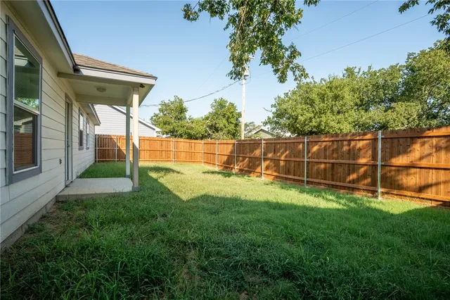 a view of backyard with trampoline