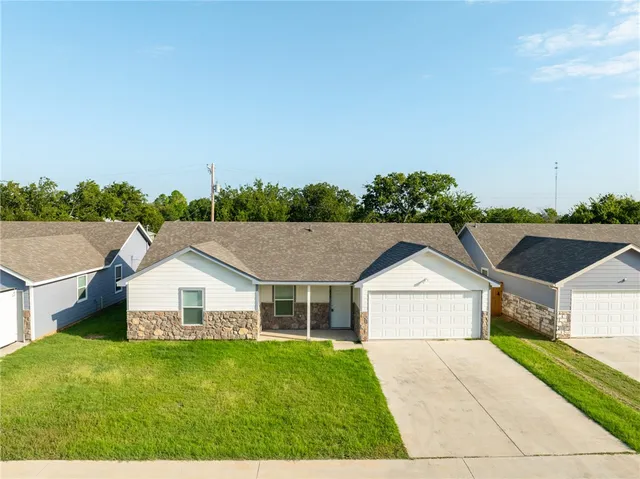 a aerial view of a house with a yard and garage