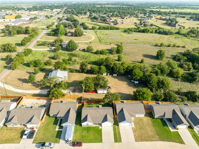 an aerial view of residential houses with outdoor space