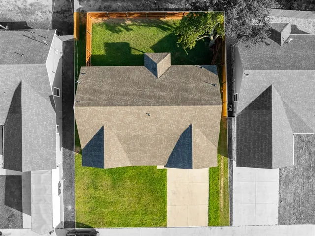 an aerial view of a house with a yard
