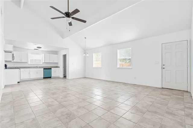 a view of a kitchen with an empty space and a window