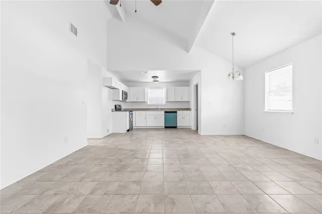 a view of a kitchen with a sink and windows