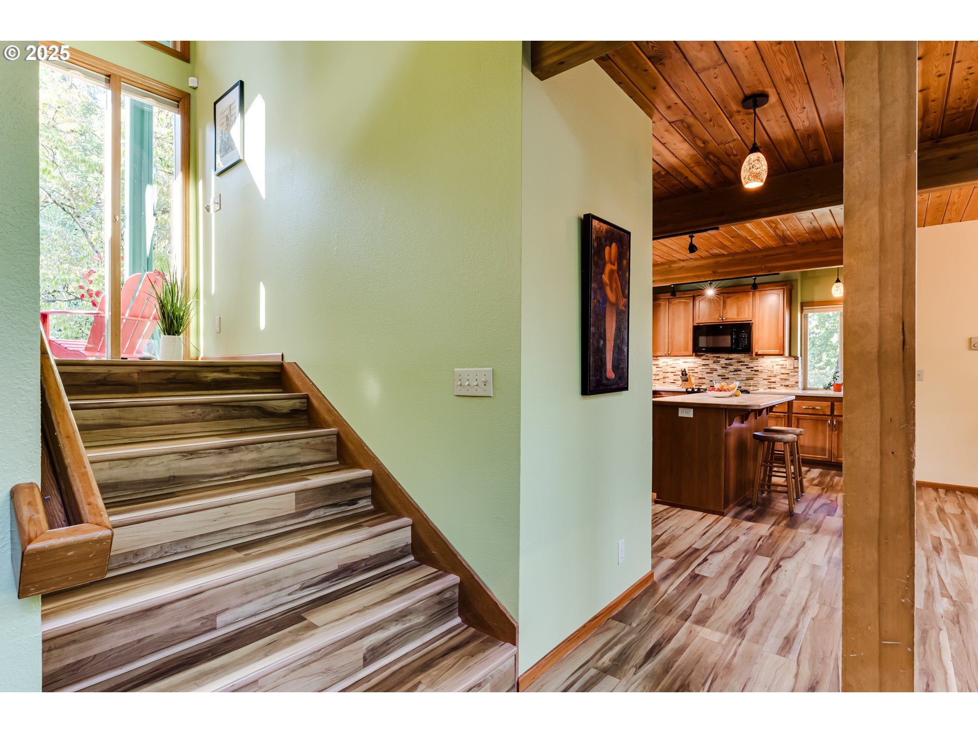 90498 Sunderman Road Springfield, OR 97478 - Photo 8 of 47 a view of a hallway with wooden floor and a kitchen