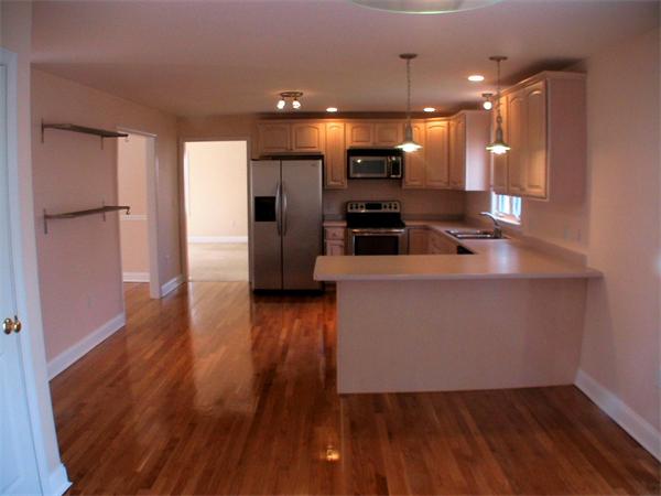 30 Corbin Road Dudley, MA 01571 - Photo 6 of 9 a view of a room with wooden floor and a kitchen