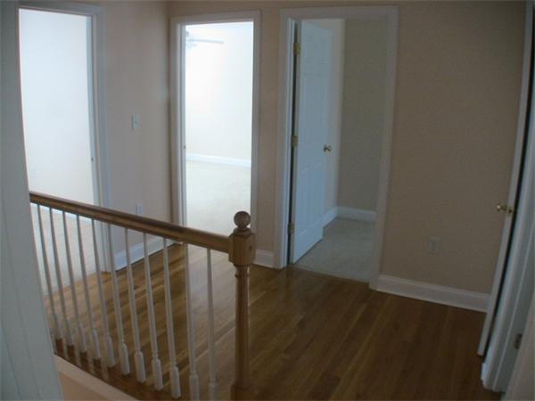 30 Corbin Road Dudley, MA 01571 - Photo 7 of 9 a view of a hallway with wooden floor and stairs