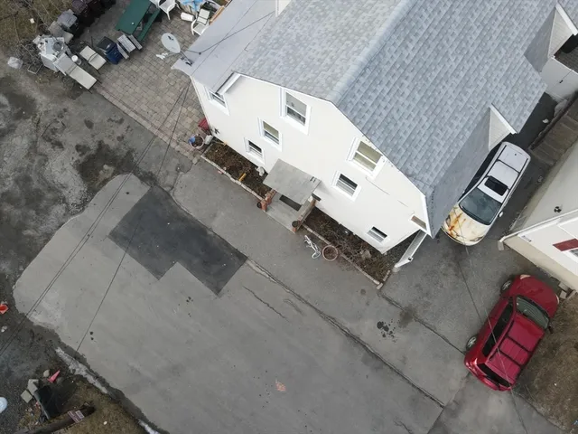 an aerial view of a house with a yard