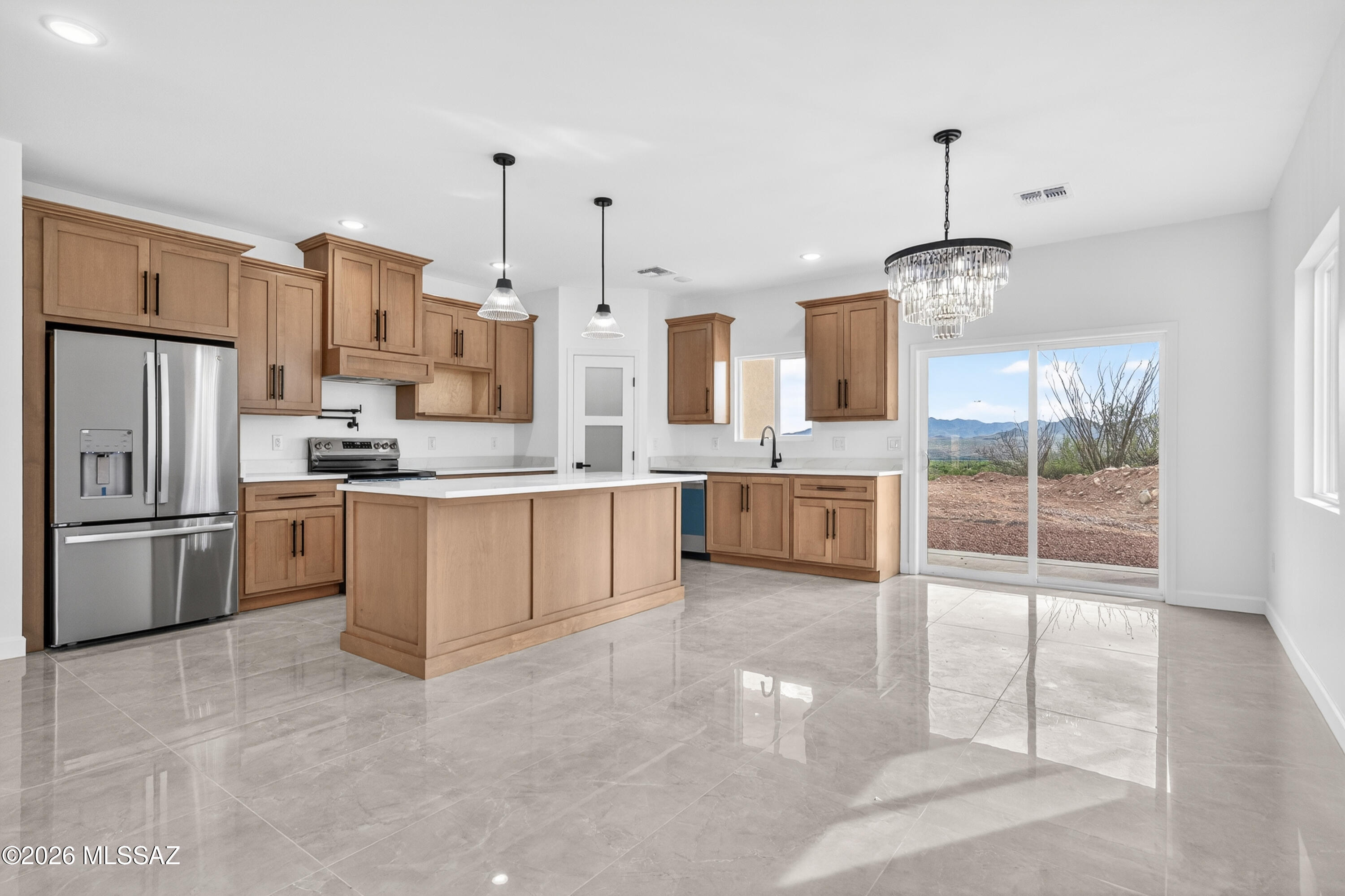 1834 Circulo Glorieta Rio Rico, AZ 85648 - Photo 10 of 35 a large kitchen with kitchen island a large counter top stainless steel appliances and cabinets