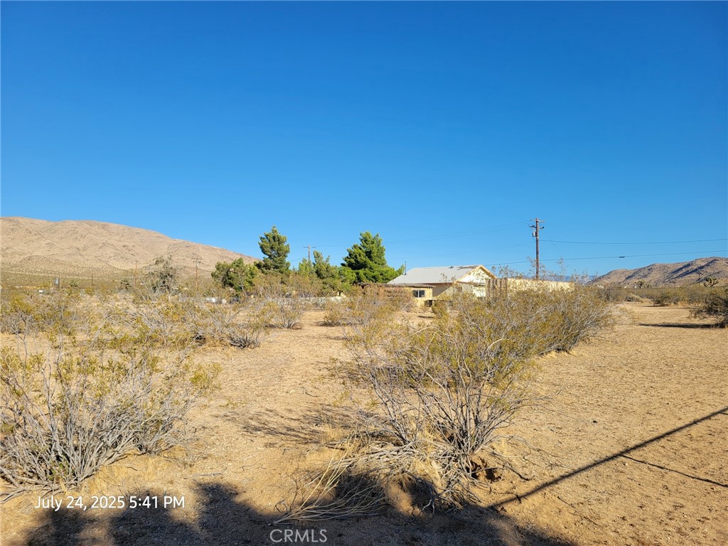 27177 Cahuilla Road Apple Valley, CA 92307 - Photo 15 of 75 a view of a dry yard with mountains in the background