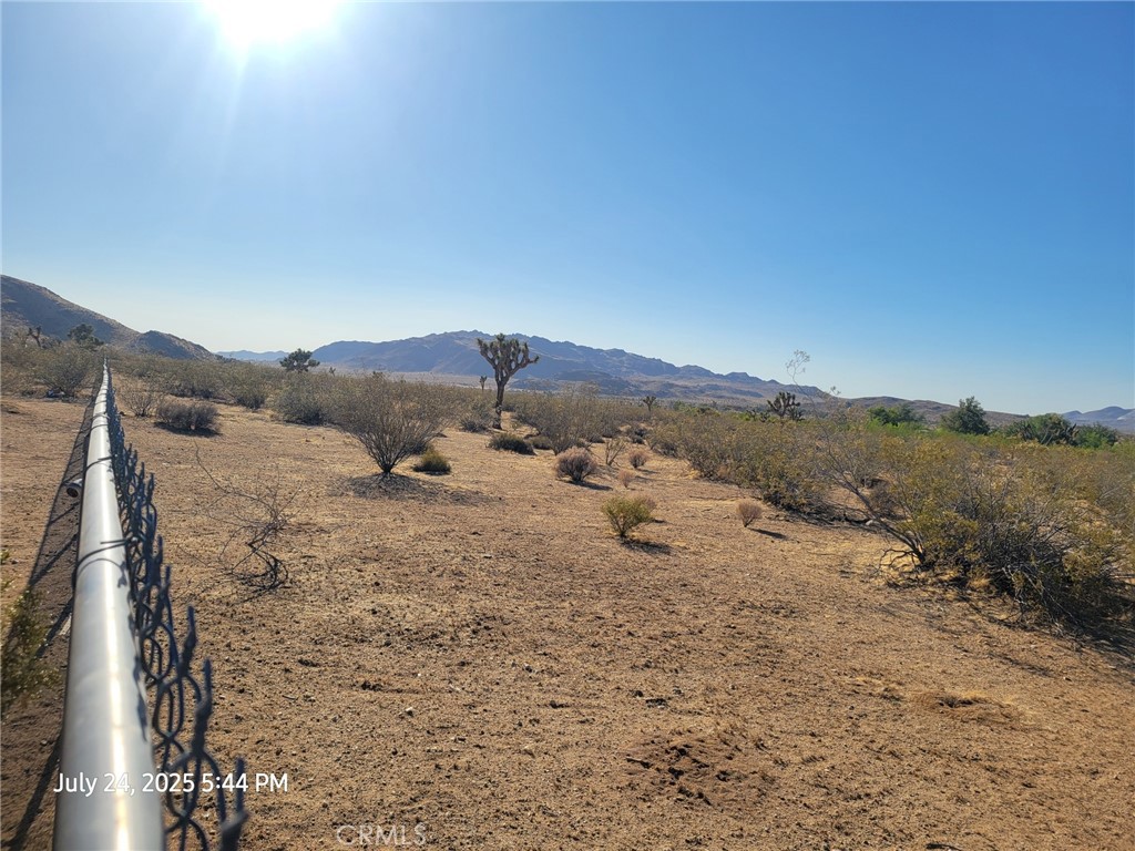 27177 Cahuilla Road Apple Valley, CA 92307 - Photo 29 of 75 a view of a dry yard with mountains in the background