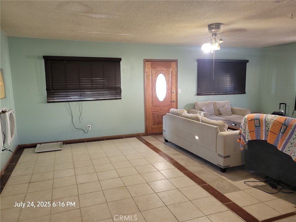 27177 Cahuilla Road Apple Valley, CA 92307 - Photo 64 of 75 a living room with a couch and a mirror