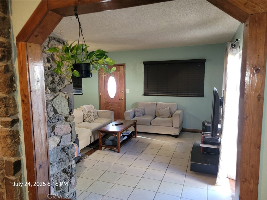 27177 Cahuilla Road Apple Valley, CA 92307 - Photo 65 of 75 a living room with furniture and a flat screen tv