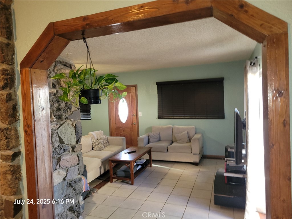 27177 Cahuilla Road Apple Valley, CA 92307 - Photo 66 of 75 a living room with furniture and a potted plant