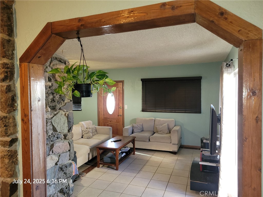 27177 Cahuilla Road Apple Valley, CA 92307 - Photo 67 of 75 a living room with furniture and a potted plant
