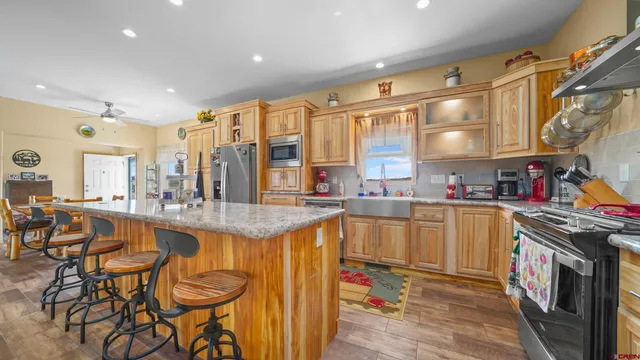 a kitchen with stainless steel appliances granite countertop a sink and cabinets