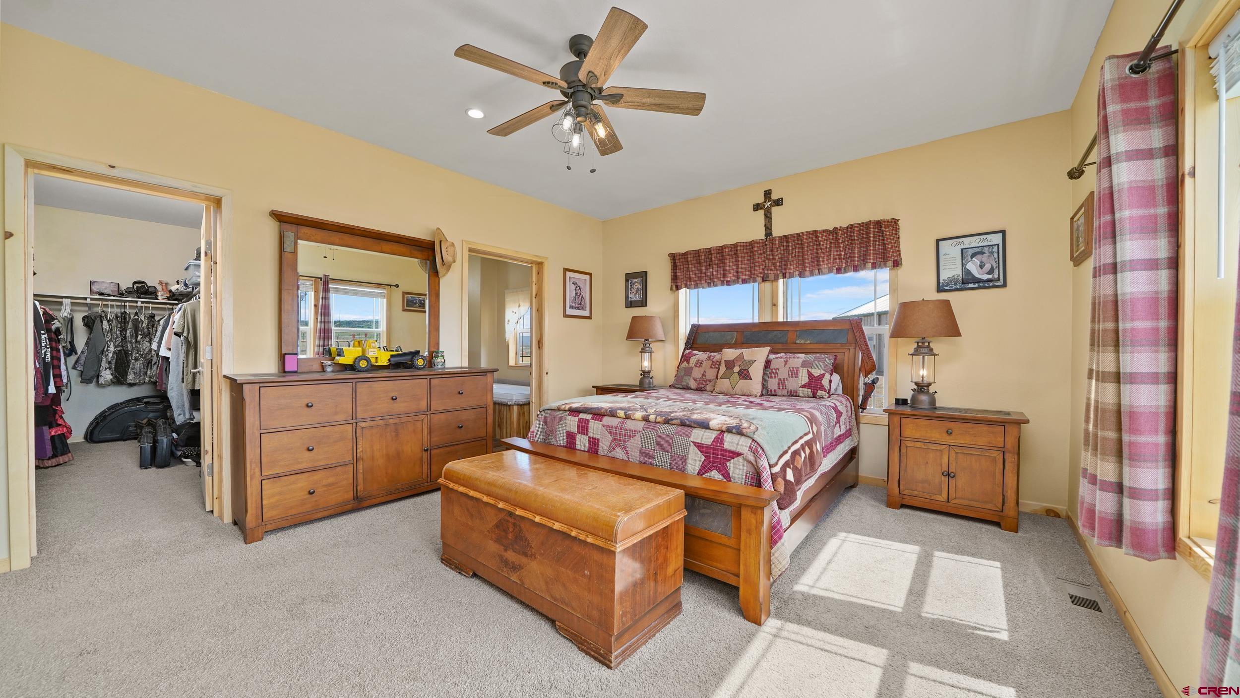 37105 II Road Redvale, CO 81431 - Photo 20 of 38 a bedroom with a bed and a chandelier