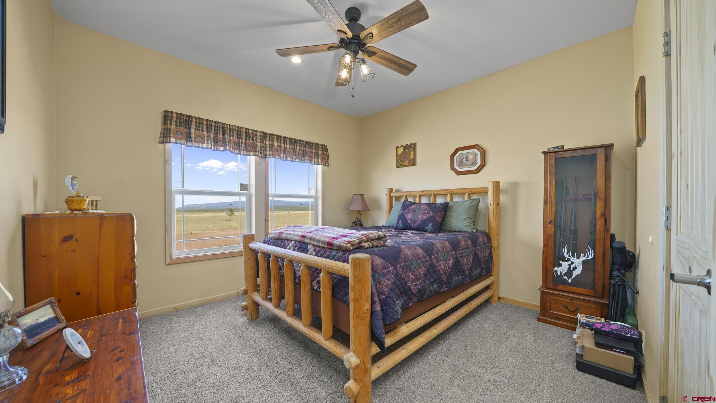 37105 II Road Redvale, CO 81431 - Photo 23 of 38 a bedroom with a bed and a chandelier