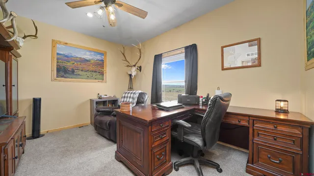 a view of a workspace with furniture