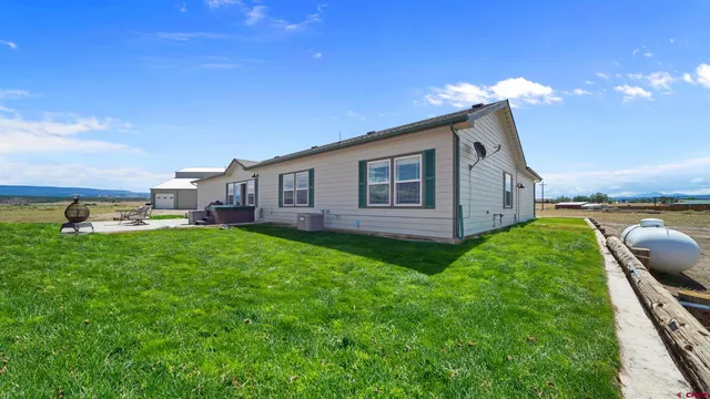 a view of a house with backyard and porch