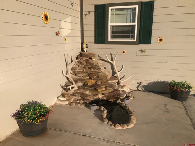 a vase of flowers sitting on a floor