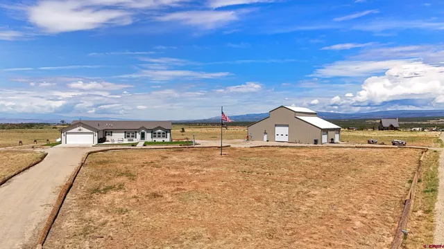 a view of a house with a yard and sitting area