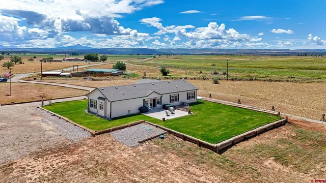 an aerial view of a house with outdoor space
