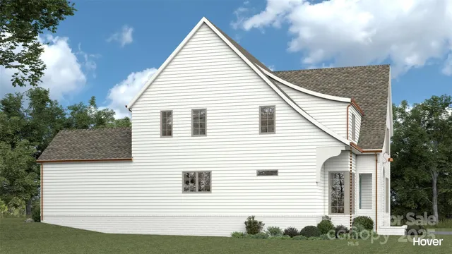 a view of a white house next to a yard