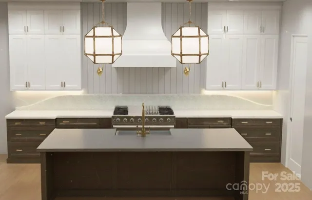 a kitchen with a sink a window and cabinets