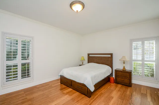 a bedroom with a bed and a large window