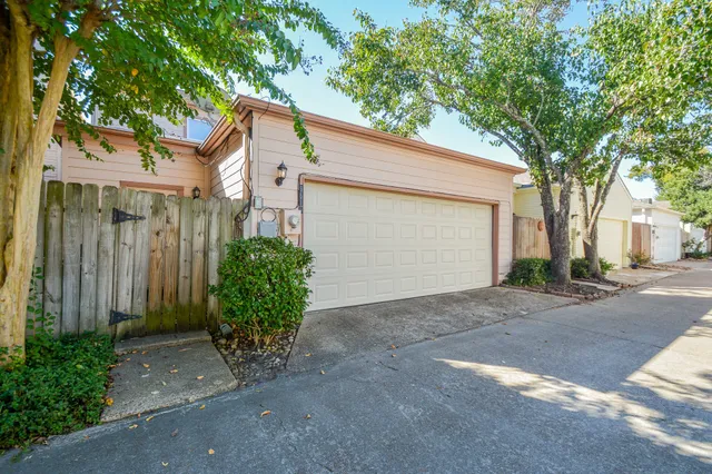 a view of a house with a yard and garage