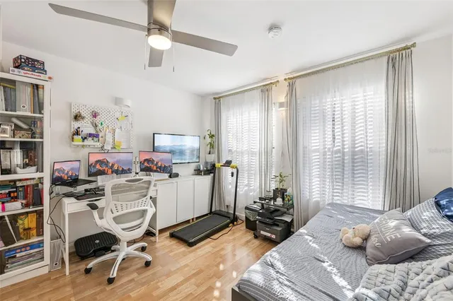 a bedroom with bed and a large window