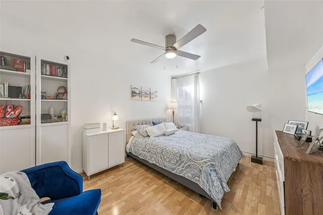 a bedroom with a bed and cabinets