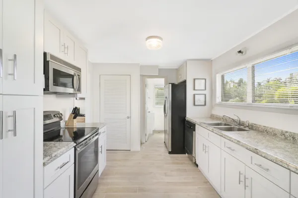 a kitchen with a sink stove and refrigerator