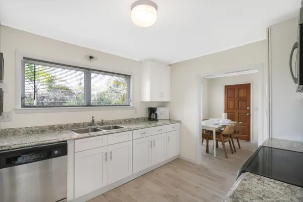a kitchen with a sink cabinets and dining table