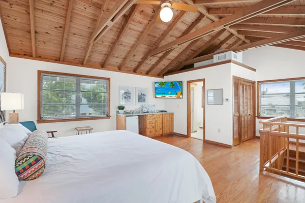 a bedroom with furniture and a large window