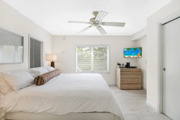 a bedroom with a bed and a window