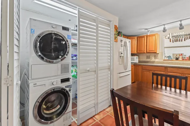 a view of a kitchen with a sink and a washer dryer