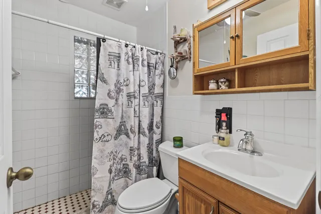 a bathroom with a sink toilet and shower