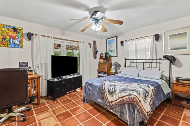 a bedroom with a bed and a flat screen tv