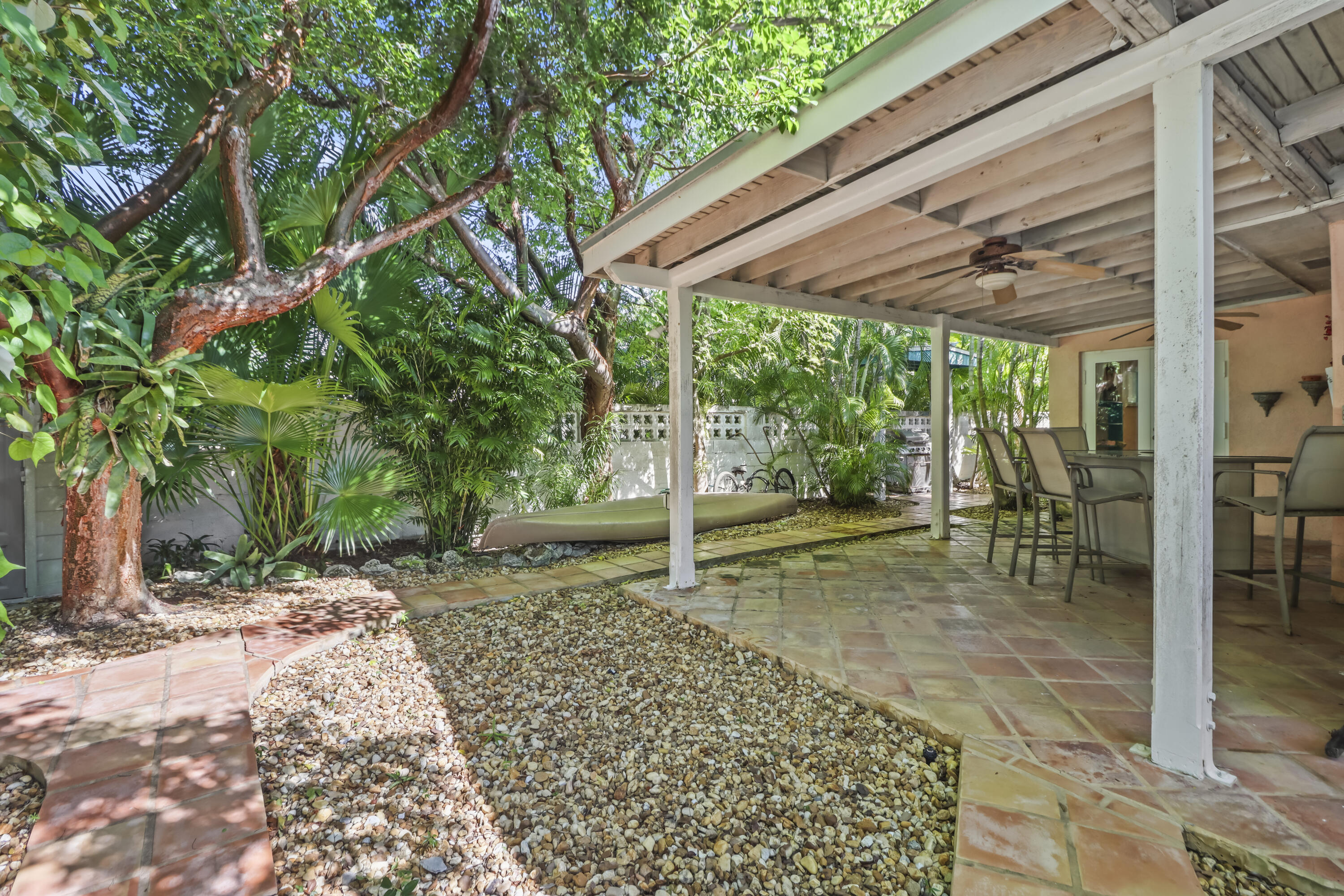 1406 Sunset Drive Key West, FL 33040 - Photo 21 of 23 a backyard with table and chairs and wooden fence